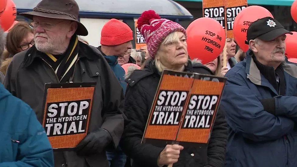 People holding placards protesting about a hydrogen trial