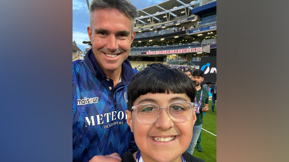 Youngster Husayn standing with former England international Kevin Pietersen at Edgbaston