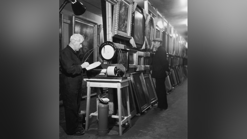 Engineer in charge J.R. Jones takes a reading of the relative humidity in a subterranean chamber at Manod Quarry, north Wales