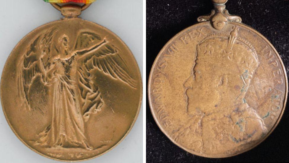 Two medals, one that look like gold, one with a woman with an outstretched arm. and another of a King
