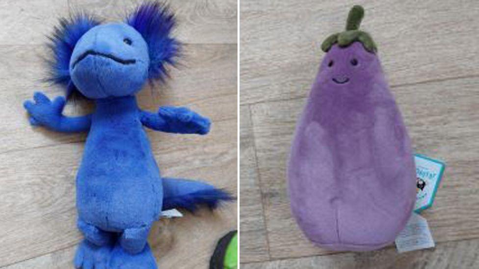 A photo of two Jellycat soft toys seized from Smith's house. One is a blue axolotl white the other is a purple coloured aubergine.