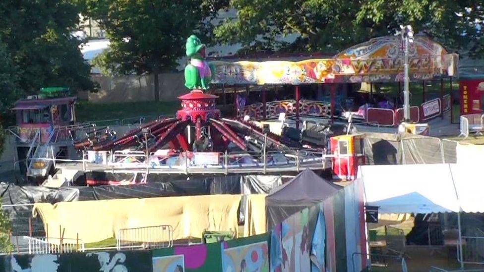 Tarpaulin seen around one funfair rides