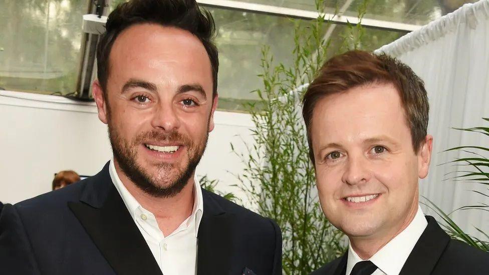 Ant McPartlin and Declan Donnolley wearing white shirts and black suit jackets