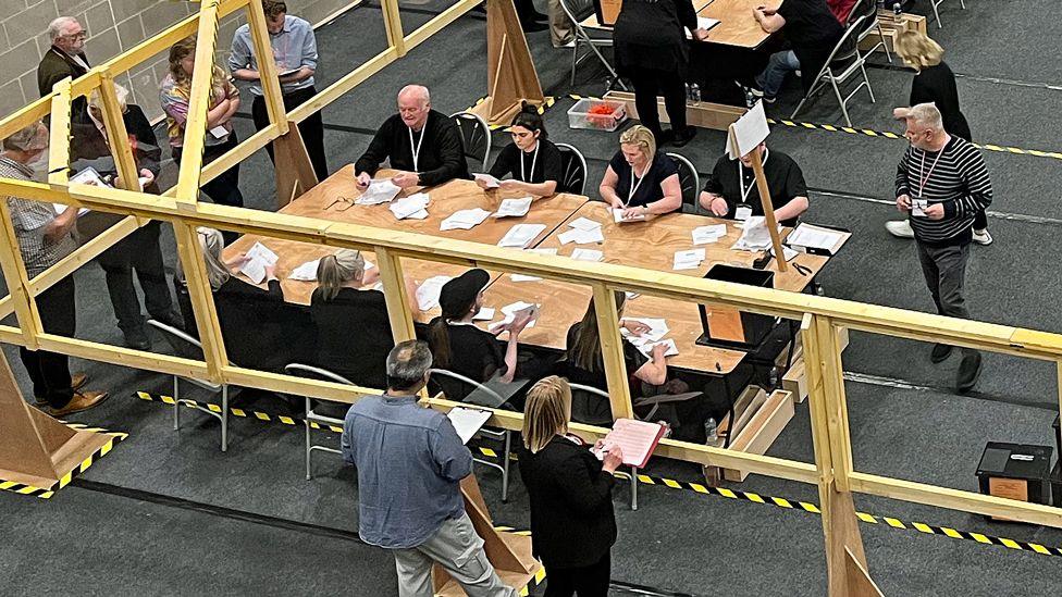 A large hall area with tables dotted around during the count for the 2024 general election