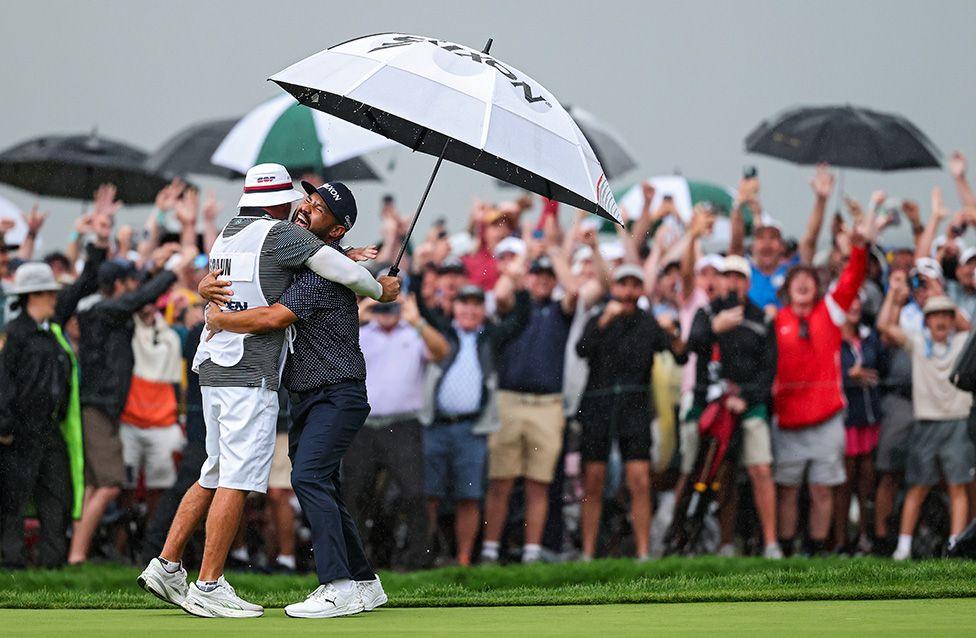 J. J. Spaun celebrates with caddie Mark Carens after winning on the 18th green during the final round of the 125th U.S. OPEN in Oakmont, Pennsylvania. Photo by Patrick Smith