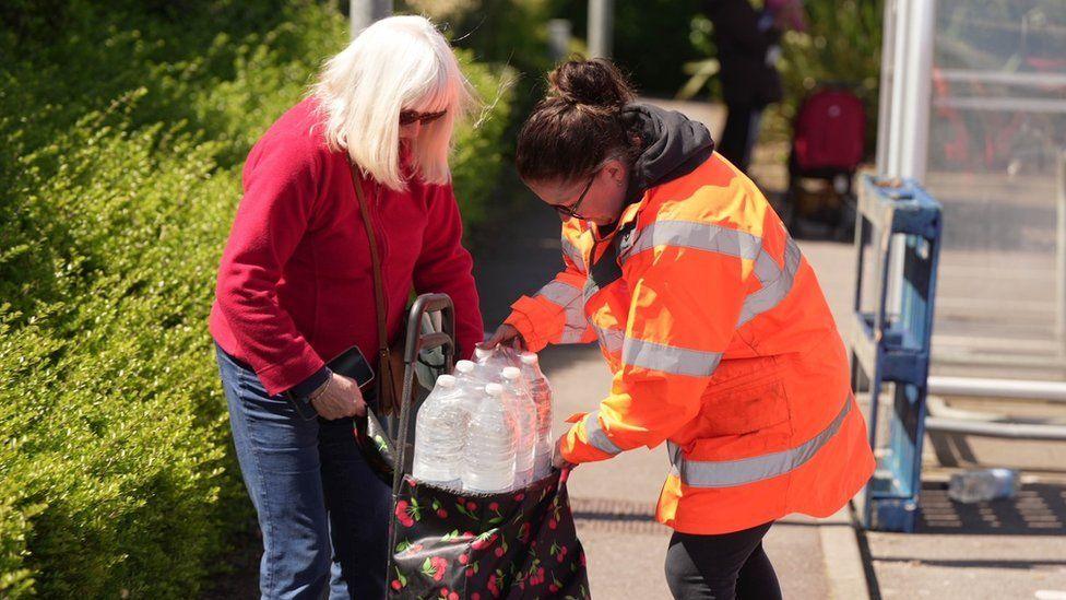 People at bottled water station