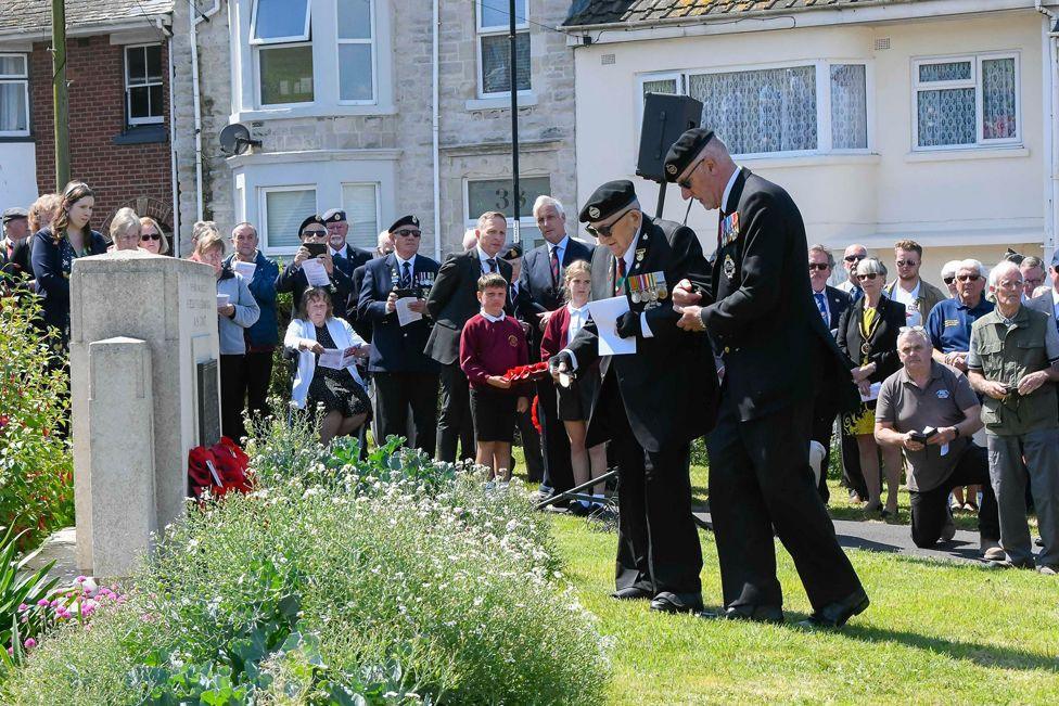 Veterans lay wreaths at the American war memorial in Victoria Gardens on the Isle of Portland in Dorset.