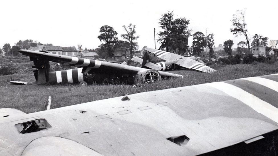 Black and white image of gliders landed in a field in France on the 6 June 1944