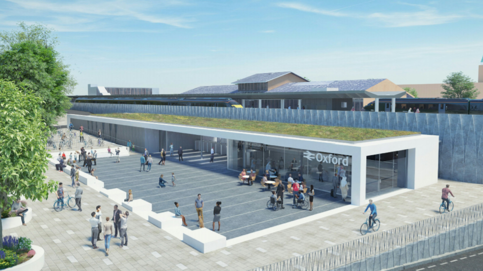 An artist's impression of the new station. It is a long building with glass windows on one side and a pedestrianised square outside. A train platform can be glimpsed over the top of a barrier.