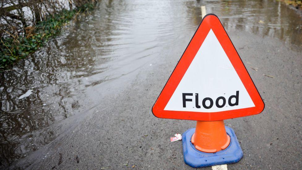 Flood sign on road