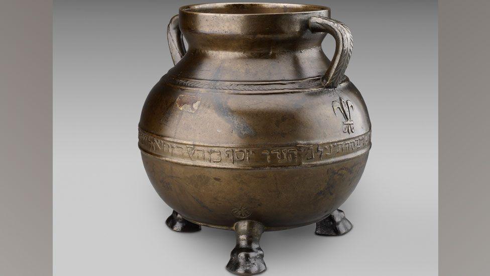 The Bodleian Bowl, a two-handled bronze cauldron inscribed in relief with words in Hebrew, standing on four legs, three in sight, dating to the 13th Century