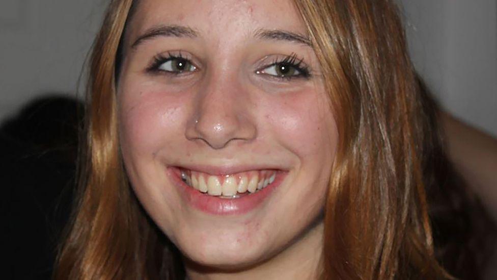 Alice Figueiredo close-up on face. She smiles and looks slightly off-camera