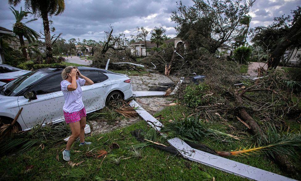 Marie Cook reacts to the damage to her home in the Binks Estates community after a tornado formed by Hurricane Milton touched down striking homes in The Preserve and Binks Estate among others in its path in Wellington, Florida, U.S. October 9, 2024. 