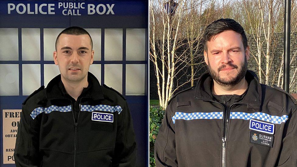 Insp Leon Usher standing in police uniform outside lift designed as a blue police phone box. PC Scott Dobinson standing in police uniform outside. They both have short hair. 