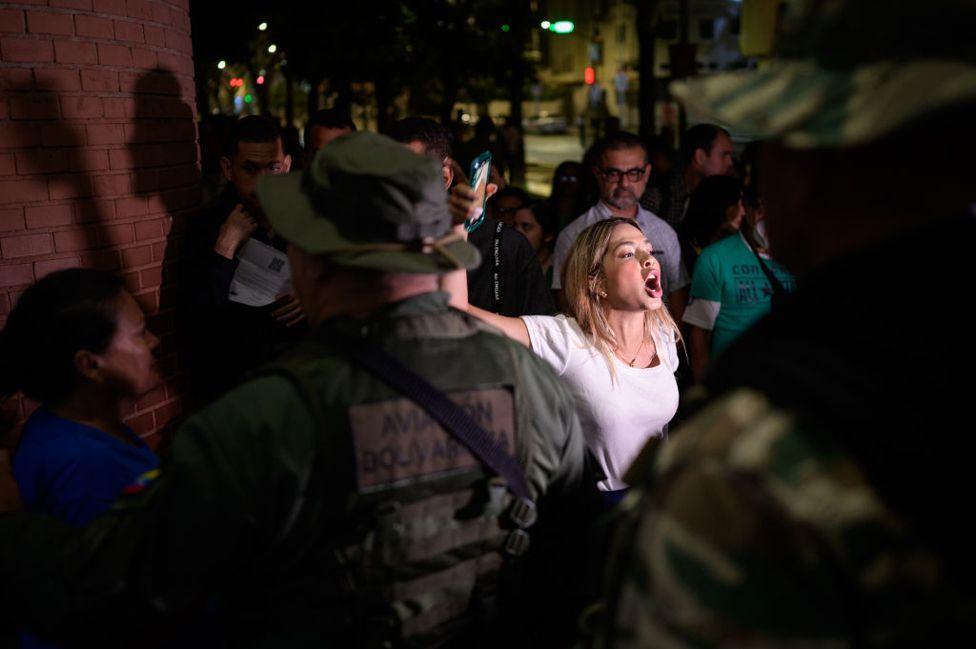 A polling supervisor shouts at the Bolivarian National Guard (GNB) to allow access to a polling station during the presidential election in Caracas, Venezuela, on Sunday, July 28, 2024.