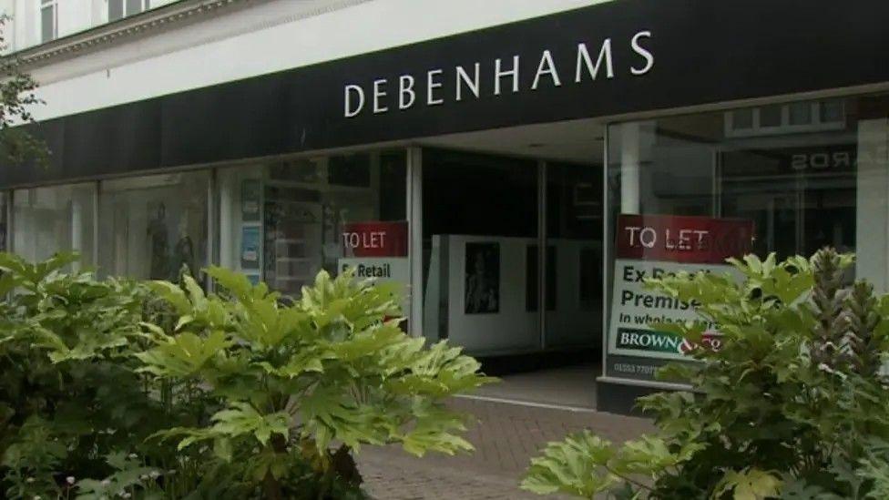 The outside of the former Debenhams store in King's Lynn, which has To Let signs in the window.