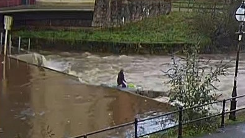 A CCTV image of River Cleddau. The shows the figure, which is one of the paddleboarders from the group, at the weir.