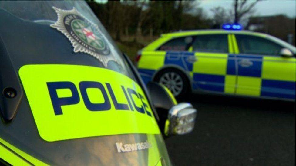 Police car on road with blue lights on 