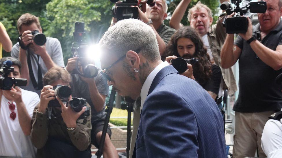 Chris Brown, pictured in front of photographers, arrives at Southwark Crown Court on Friday morning