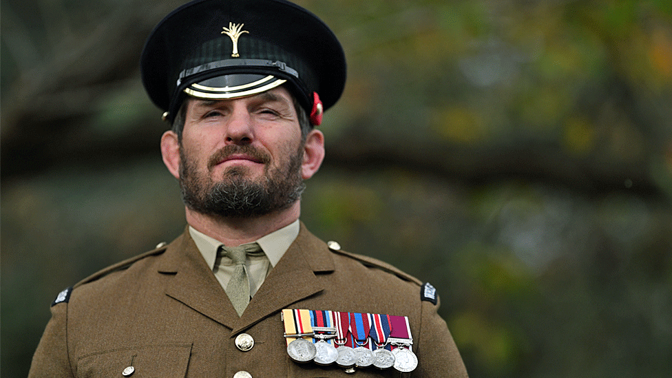 Serviceman dressed in uniform with medals pinned to his chest