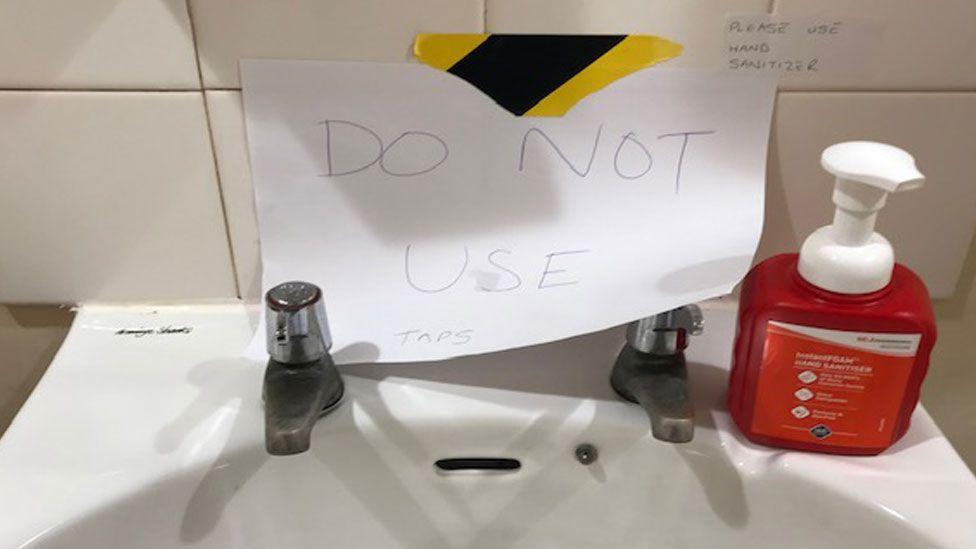 Hospital sink with out of use note on it