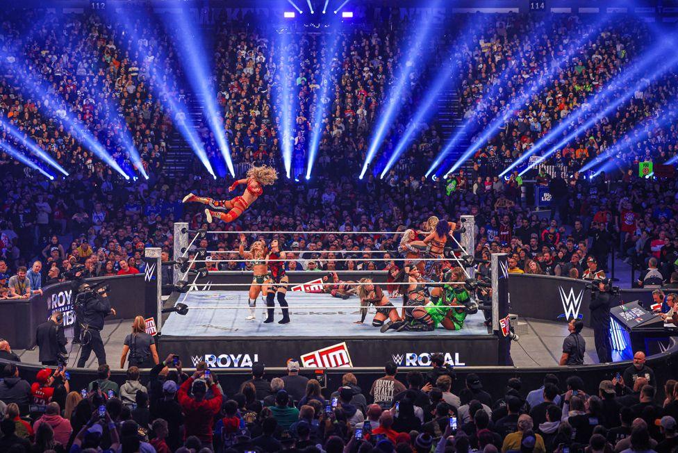 Charlotte Flair in the air during wrestling's Women's Royal Rumble at Lucas Oil Stadium in Indianapolis, Indiana