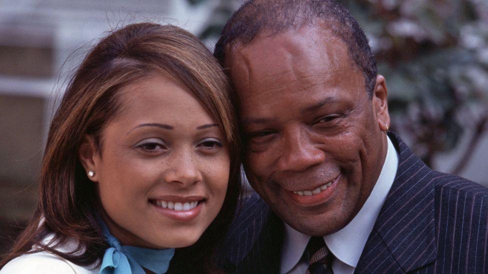 Kidada and Quincy Jones posing, smiling with their heads close together