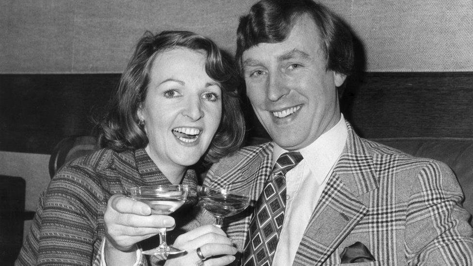 Penelope Keith and Rodney Timson's marriage in 1978. They are holding up glasses of champagne to the camera.