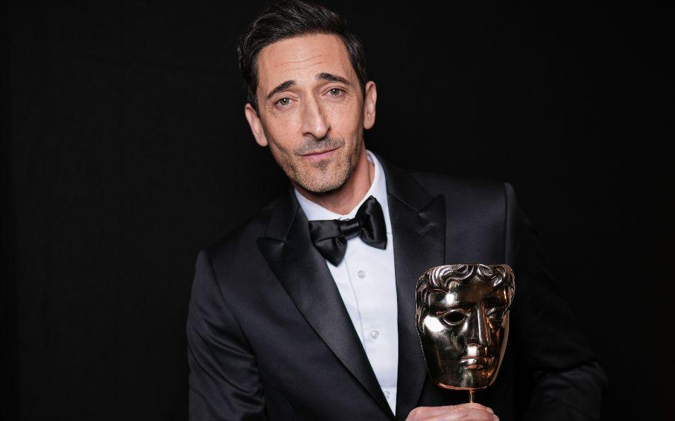 Adrien Brody holding his Bafta trophy