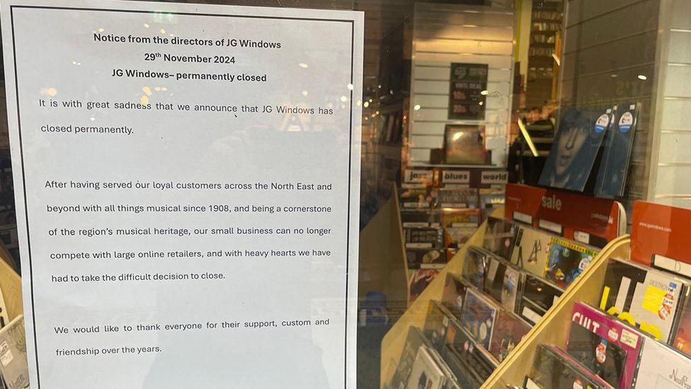 The piece of paper taped onto the JG Window shop front. It reads: "Notice from the directors of JG Window, 29th November 2024, JG Windows permanently closed".