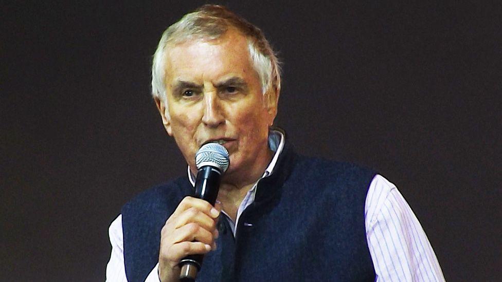 Johnny Walker speaking into a microphone on stage at the BBC Radio 2 Festival In A Day at Hyde Park on September 8, 2013