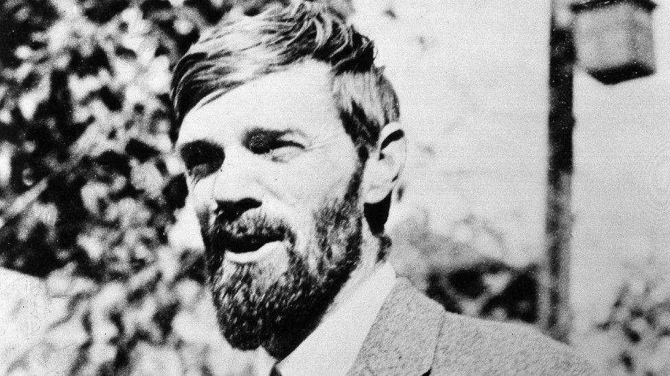 Archive shot of DH Lawrence talking to someone off camera