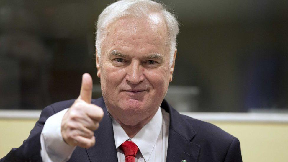 An unrepentant Mladić gives a thumbs-up at his trial at the International Court of Justice at the Hague
