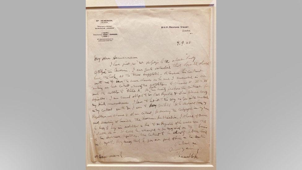 A framed, handwritten letter dated 1908 from Dracula author Bram Stoker to his publishers. The paper on which it is written is faded and discoloured.