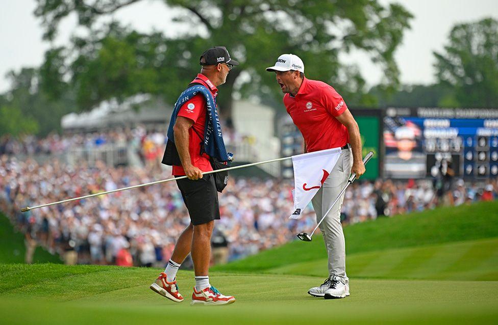 Keegan Bradley reacts to his winning birdie putt on the 18th green with his caddie Scott Vail during the final round of the Travelers Championship in Connecticut. Photo by Alex Goodlett