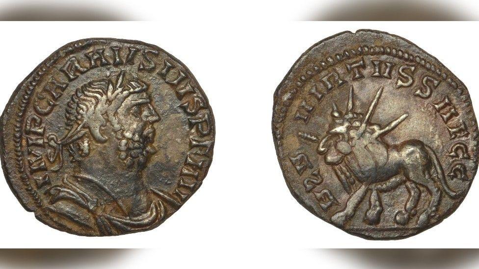 Two side of a coin, the left shows the face  Roman Emperor Carausius and the right features a Lion holding a thunderbolt. 