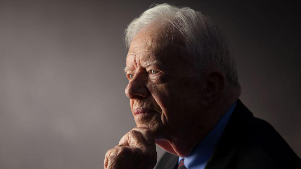 Jimmy Carter in 2011, head and shoulders with chin resting on left hand