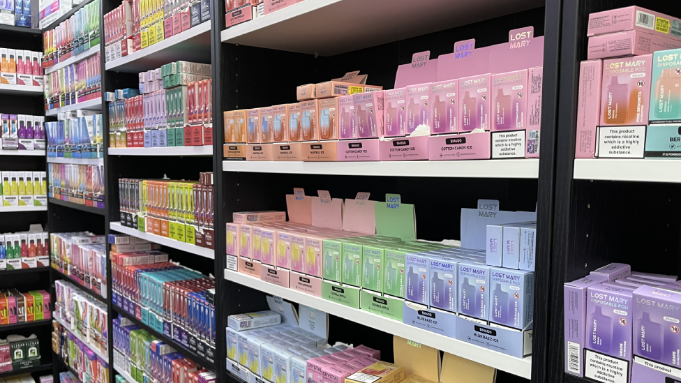 Shop shelves lined with colourful vape products