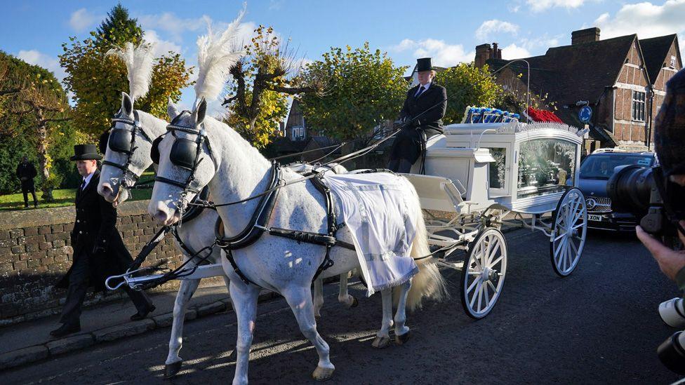 Payne's coffin arriving at the church on a white horse-drawn hearse