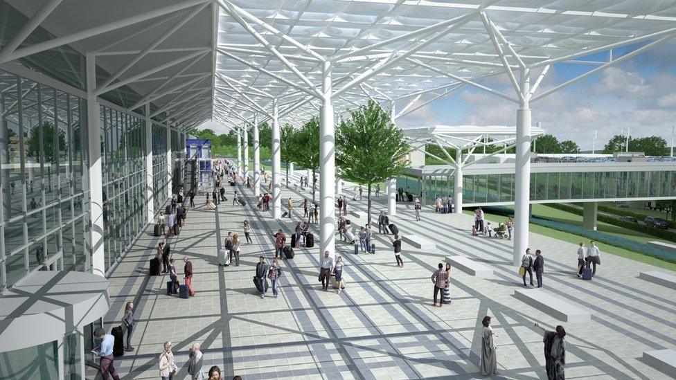 A computer generated image showing what the expanded airport would look like. It is a lot larger with paved sections outside the front and a white metal overhead shelter. 