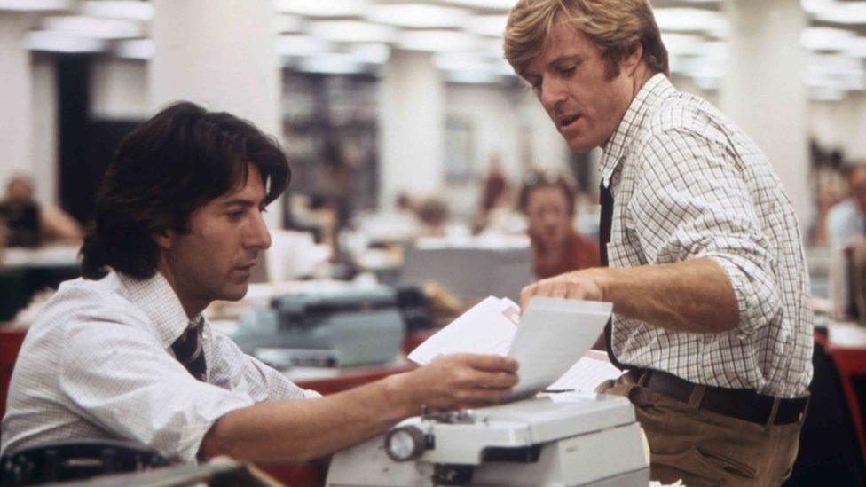 Dustin Hoffman and Robert Redford in a scene from All the President's Men. They are looking at their typewritten copy in a newsroom.