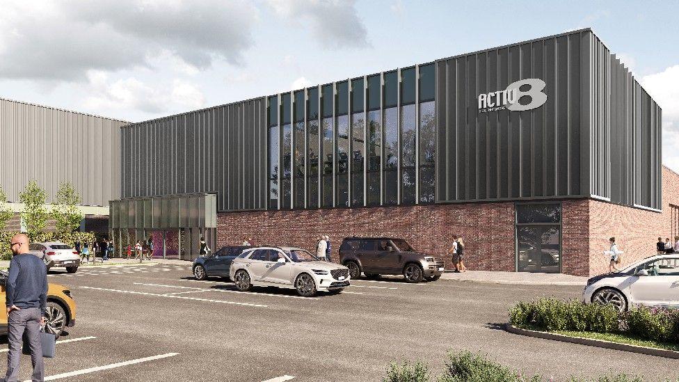 An artist's impression of what the frontage of the proposed new swimming pool and gym in Thornaby could look like. It shows a modern building with glass panels and a large parking area.