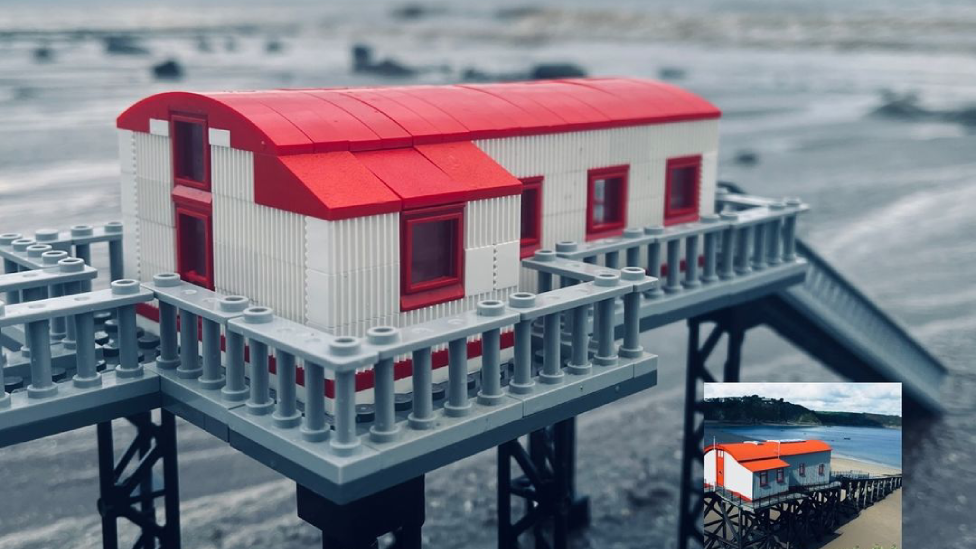 A Lego model of Tenby lifeboat station, with an inserted picture of the actual lifeboat station in the bottom right-hand corner