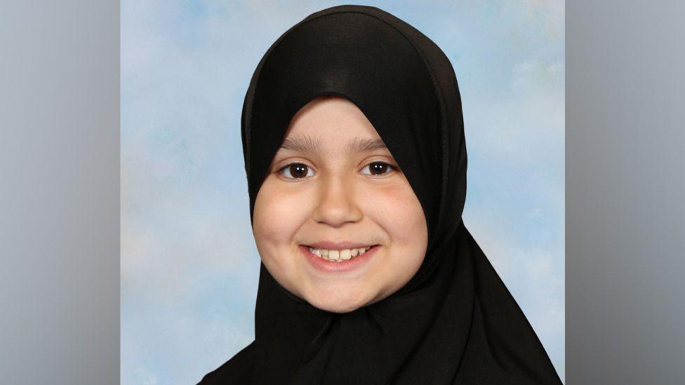 Headshot portrait of Sara Sharif wearing an Islamic hijab