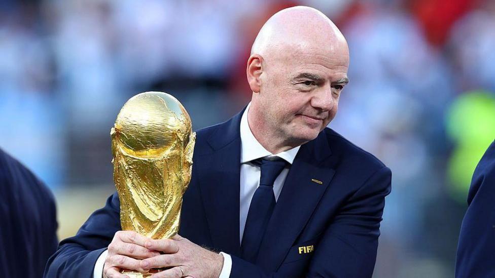 Infantino holding the World Cup