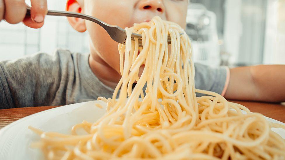 Child eating pasta
