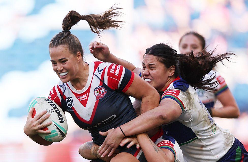 Isabelle Kelly is tackled from behind during a NRLW match between Sydney Roosters and New Zealand Warriors in Sydney, Australia.