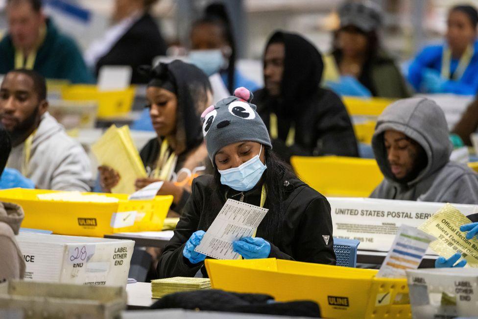 Election workers process mail-in ballots for the 2024 presidential election at a warehouse in Philadelphia, Pennsylvania, US, 5 November 2024