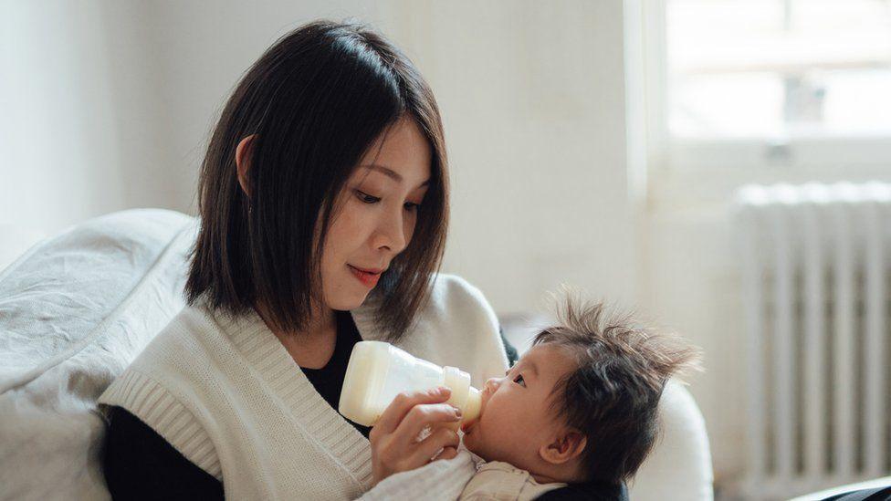 Mum feeding baby from a bottle 