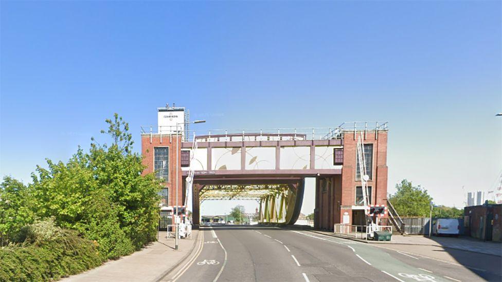 View of Drypool Bridge from the road showing the brick towers housing the lifting mechanism and the metal structure spanning the roadway